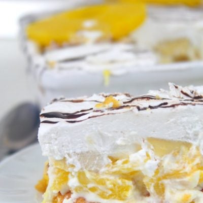 Close up image of banana split lasagna with pineapple, in a white serving plate