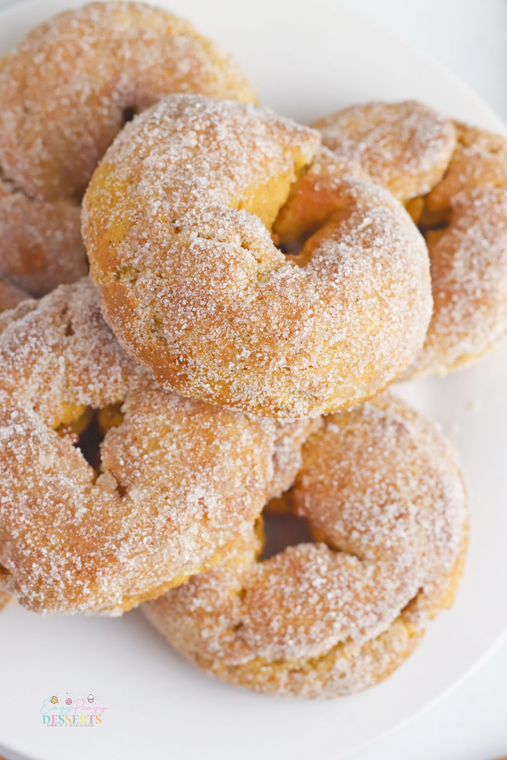 Pumpkin donuts on a white serving plate