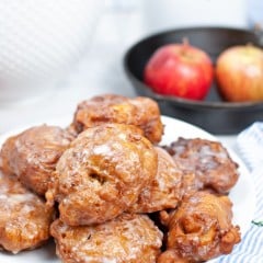 Close up image of fried homemade apple fritters with sugar glaze