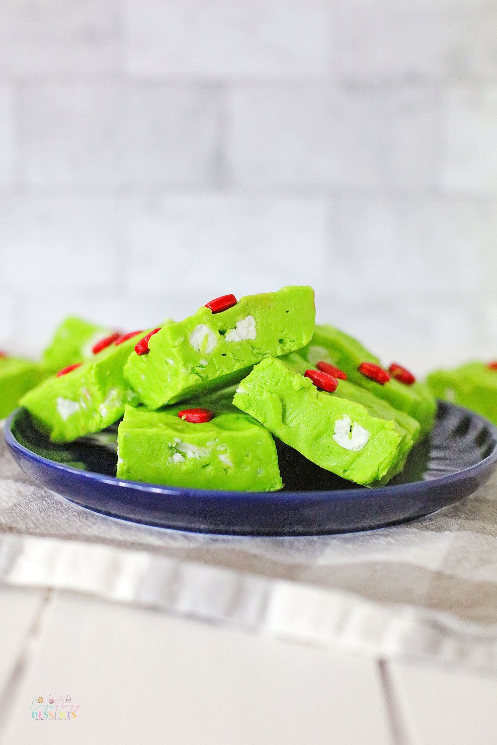 Green Christmas fudge with red heart candy and white marshmallows