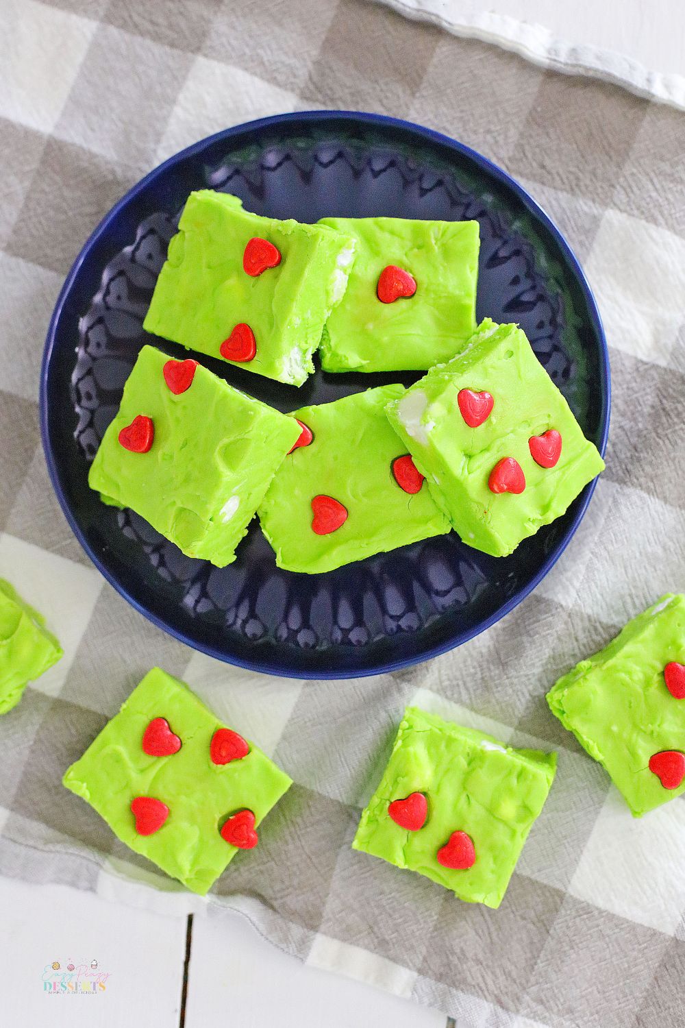 Image of Christmas fudge in green color, decorated with red hearts and white marshmallows