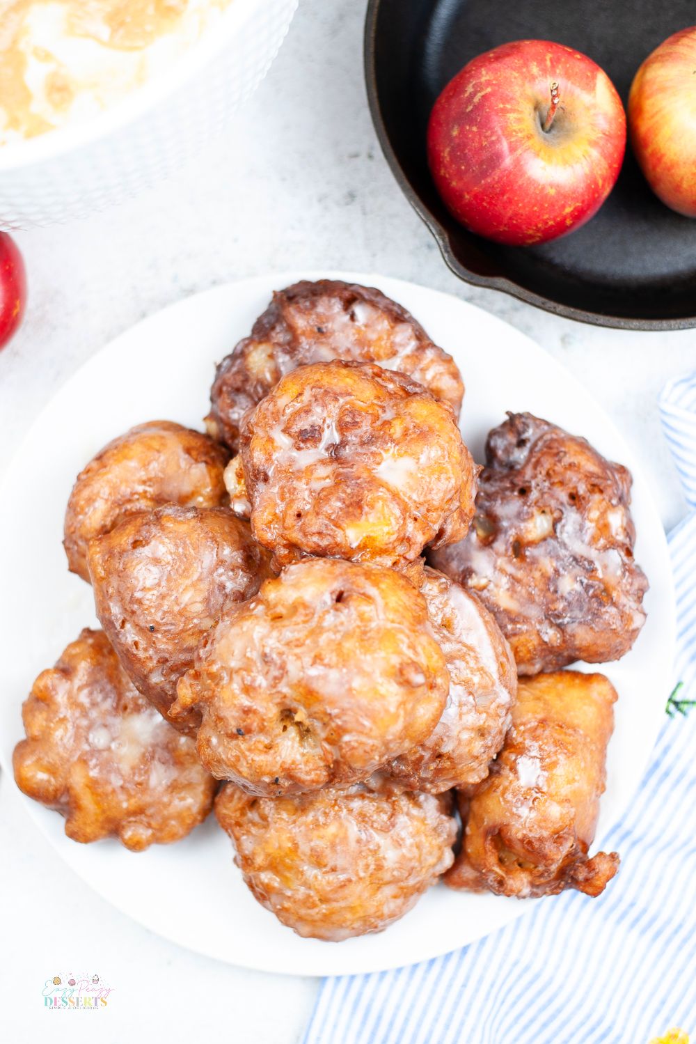Overhead image of homemade easy apple fritters in a white serving plate