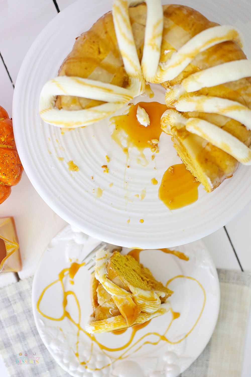 Image of fall bundt cake made with fresh pumpkin, topped with buttercream frosting and drizzled with caramel sauce