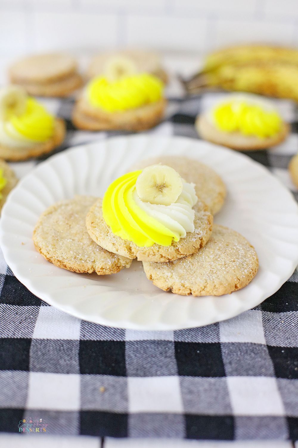 Image of frosted banana cookies on a white dessert plate