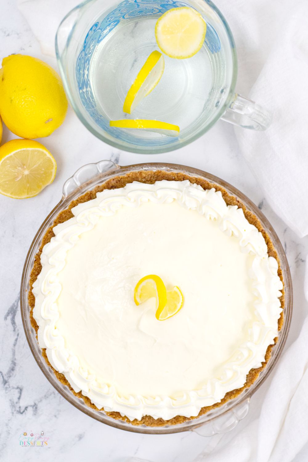 Overhead image of a whole lemon cream cheese pie in a pie dish