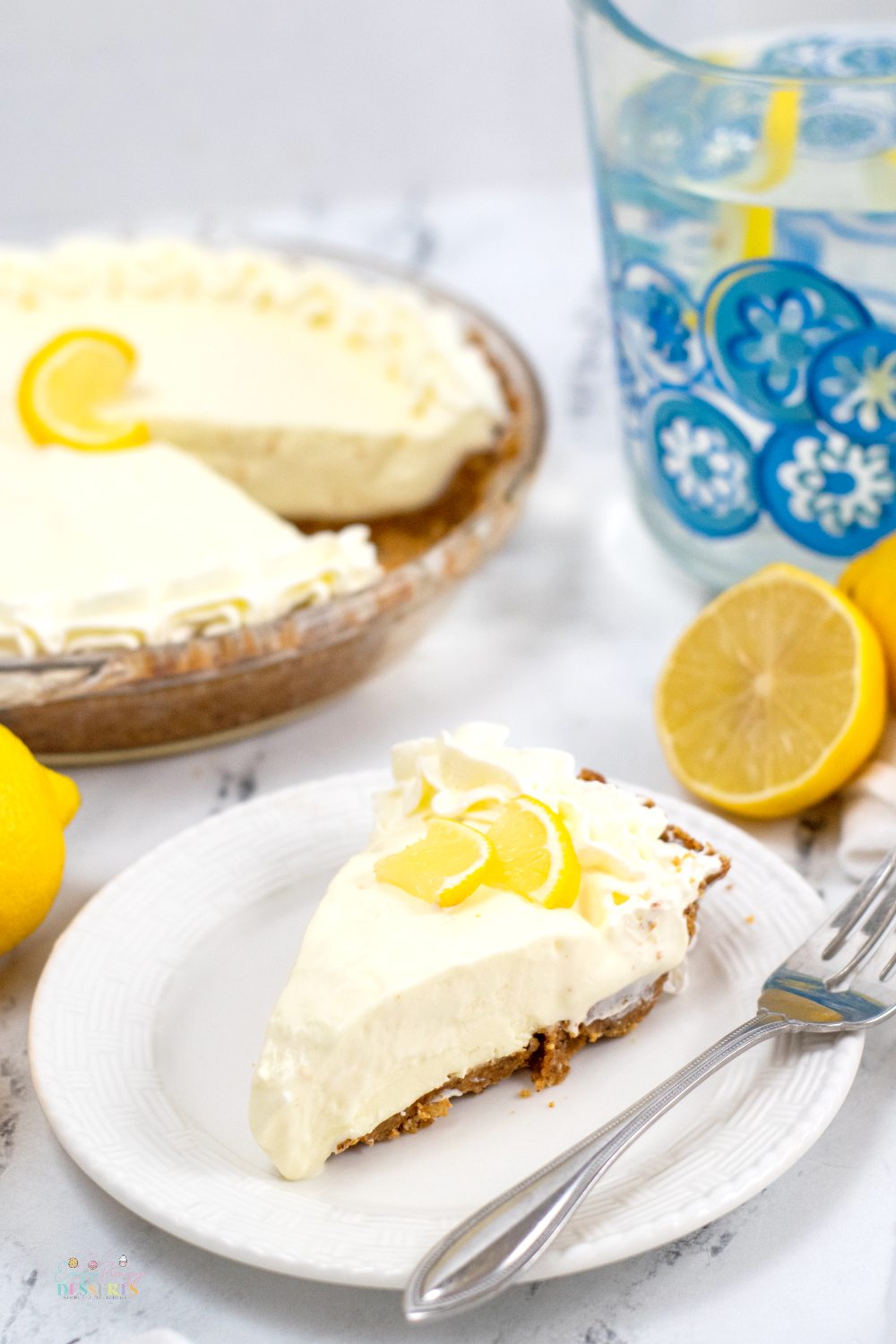 Close up image of a slice of sugar free lemon pie decorated with a slice of lemon