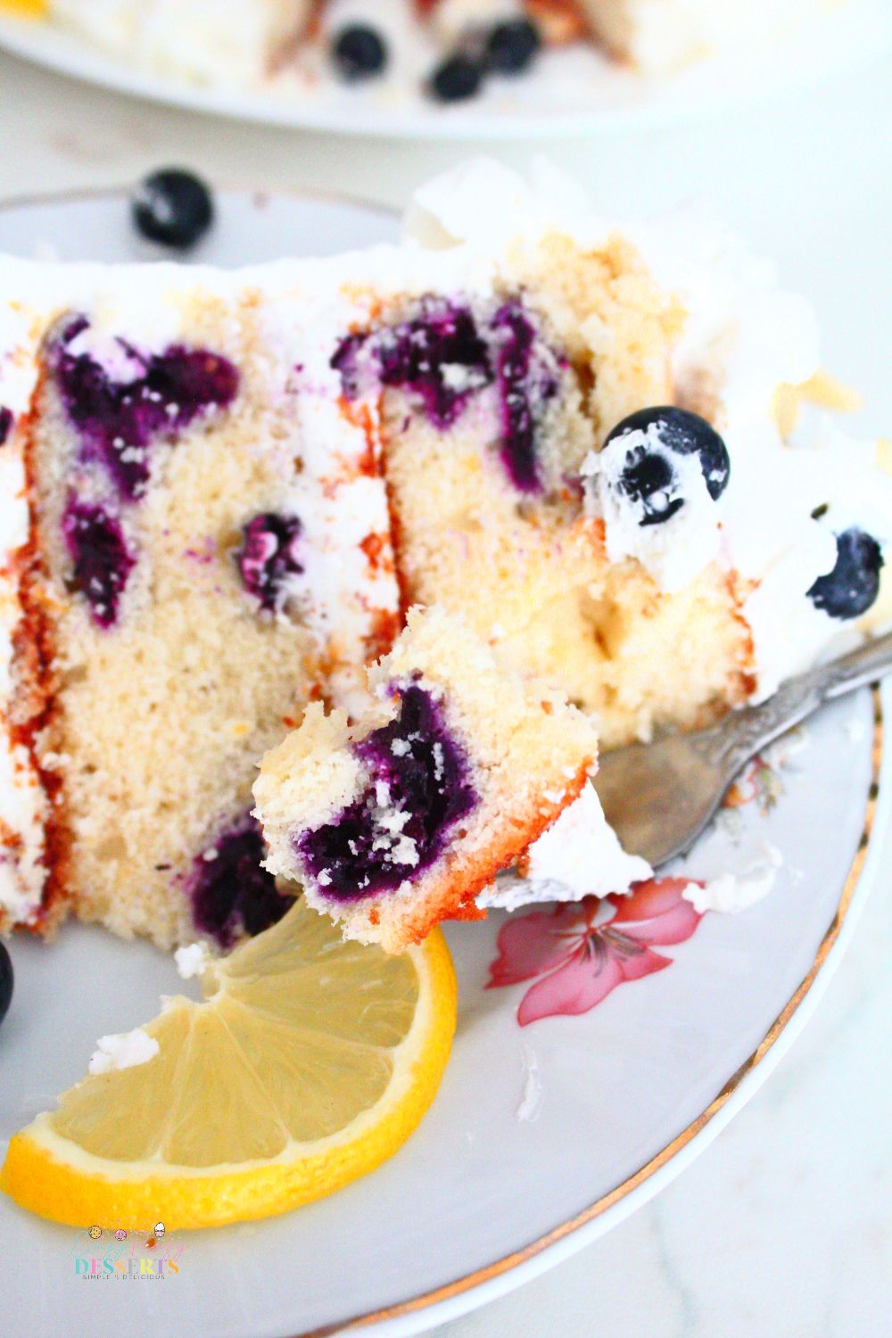 Close up image of a bite of easy lemon blueberry cake