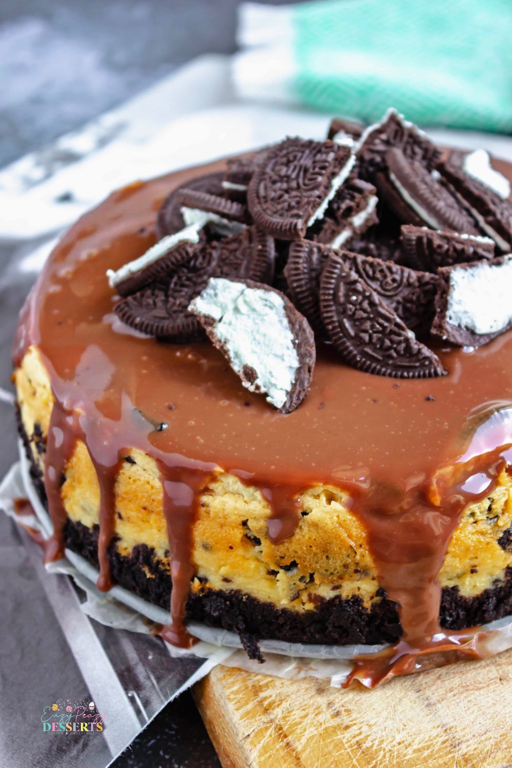 Close up image of Oreo cheesecake with chocolate ganache on top