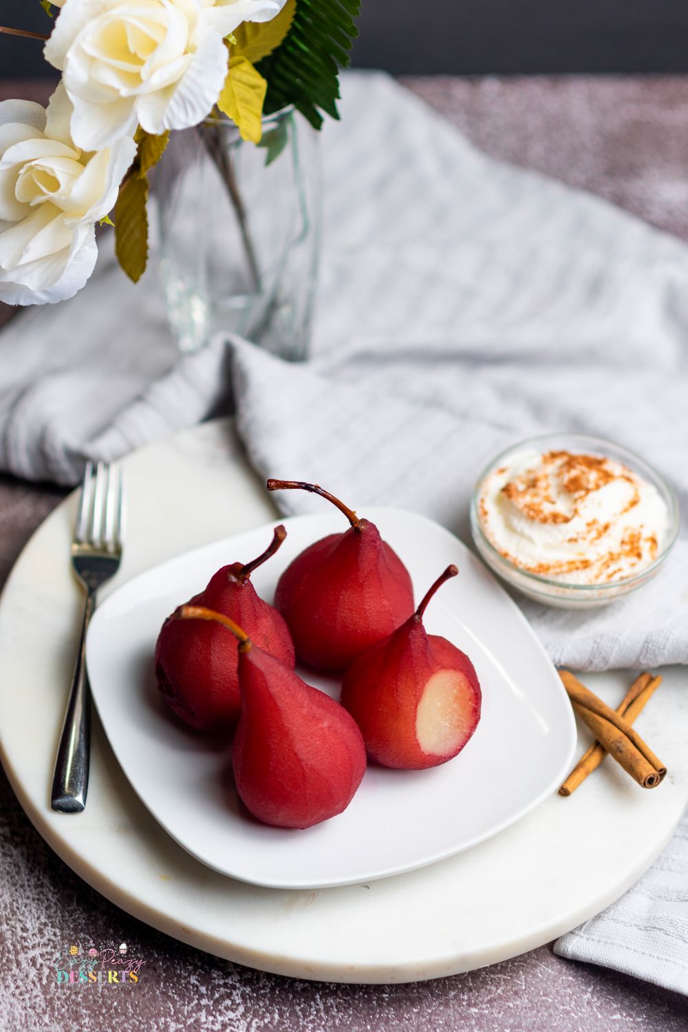 Image of pears in red wine on a white serving plate