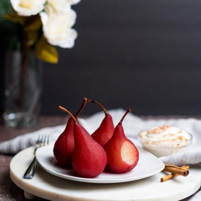 Image of pears in wine dessert on a white serving plate