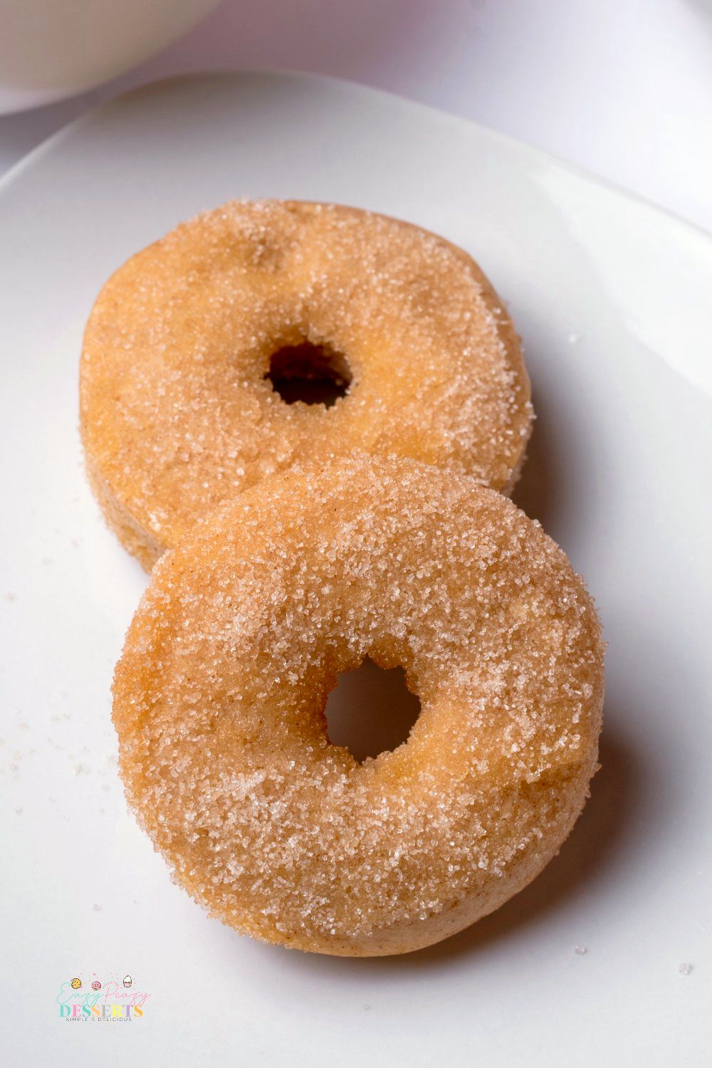Close up image of caked cinnamon sugar donuts