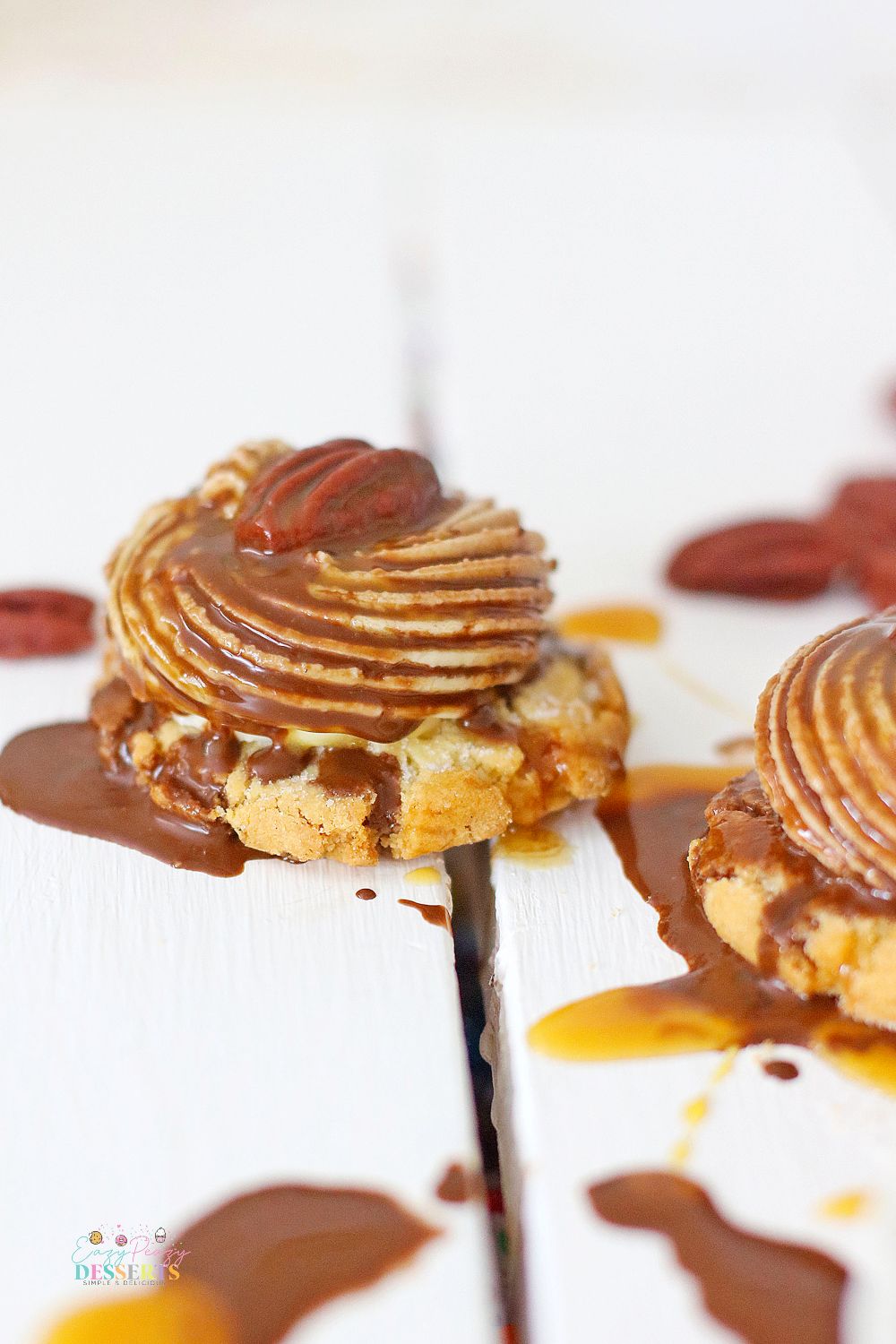 Close up image of a chocolate turtle cookie with pecan and caramel sauce