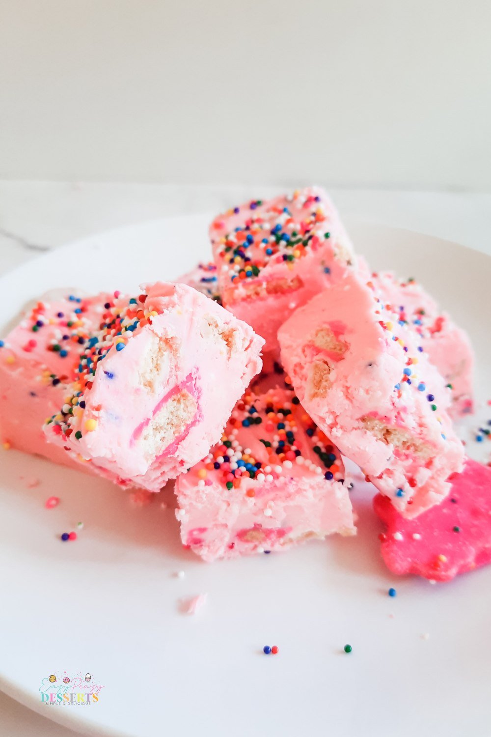 A few squares of funfetti fudge with strawberry frosting, sprinkled and circus cookies