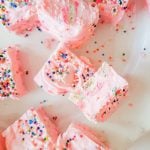Over head image of a few strawberry fudge bars with sprinkles and cookies
