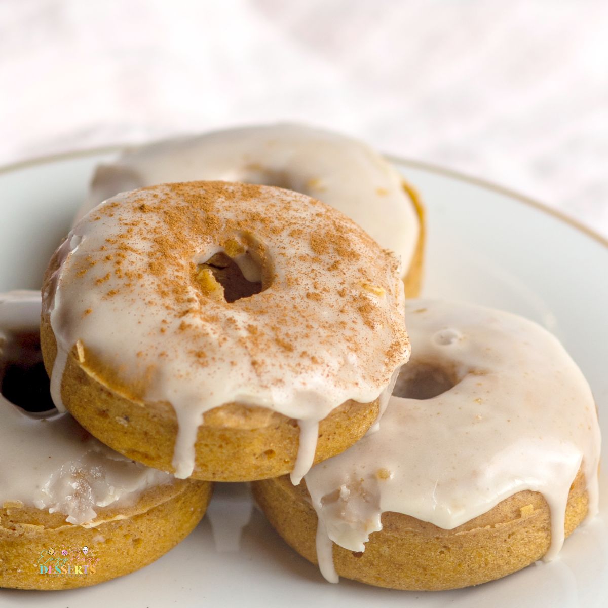 Close up image of pumpkin spice donuts with maple glaze