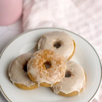 Overhead image of vegan pumpkin donuts with maple syrup glaze