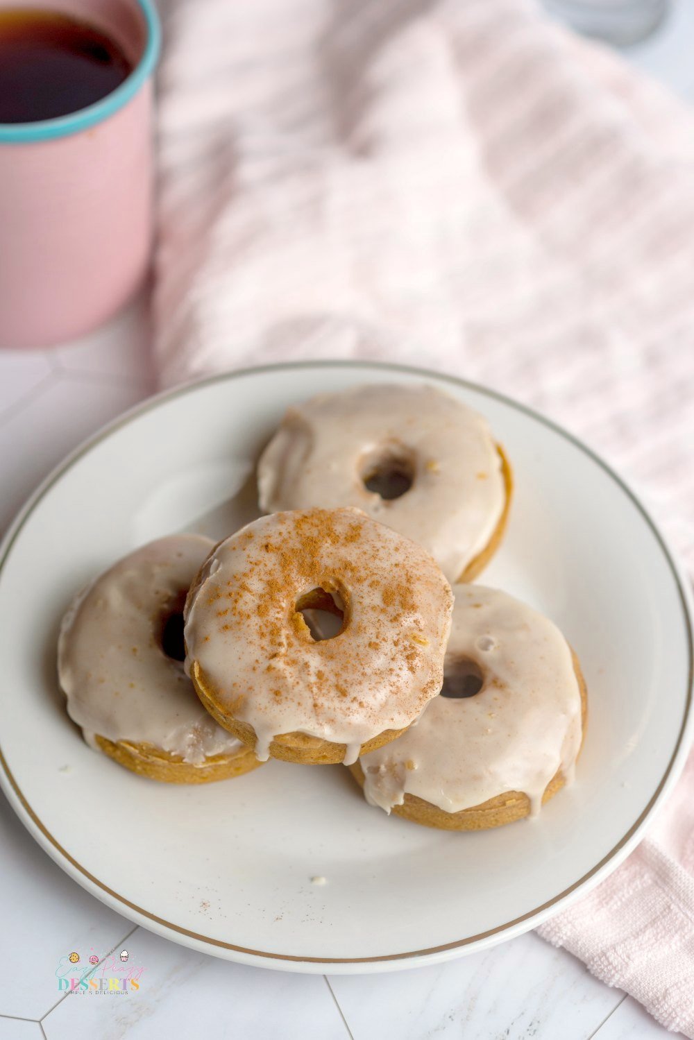Overhead image of vegan pumpkin donuts with maple syrup glaze