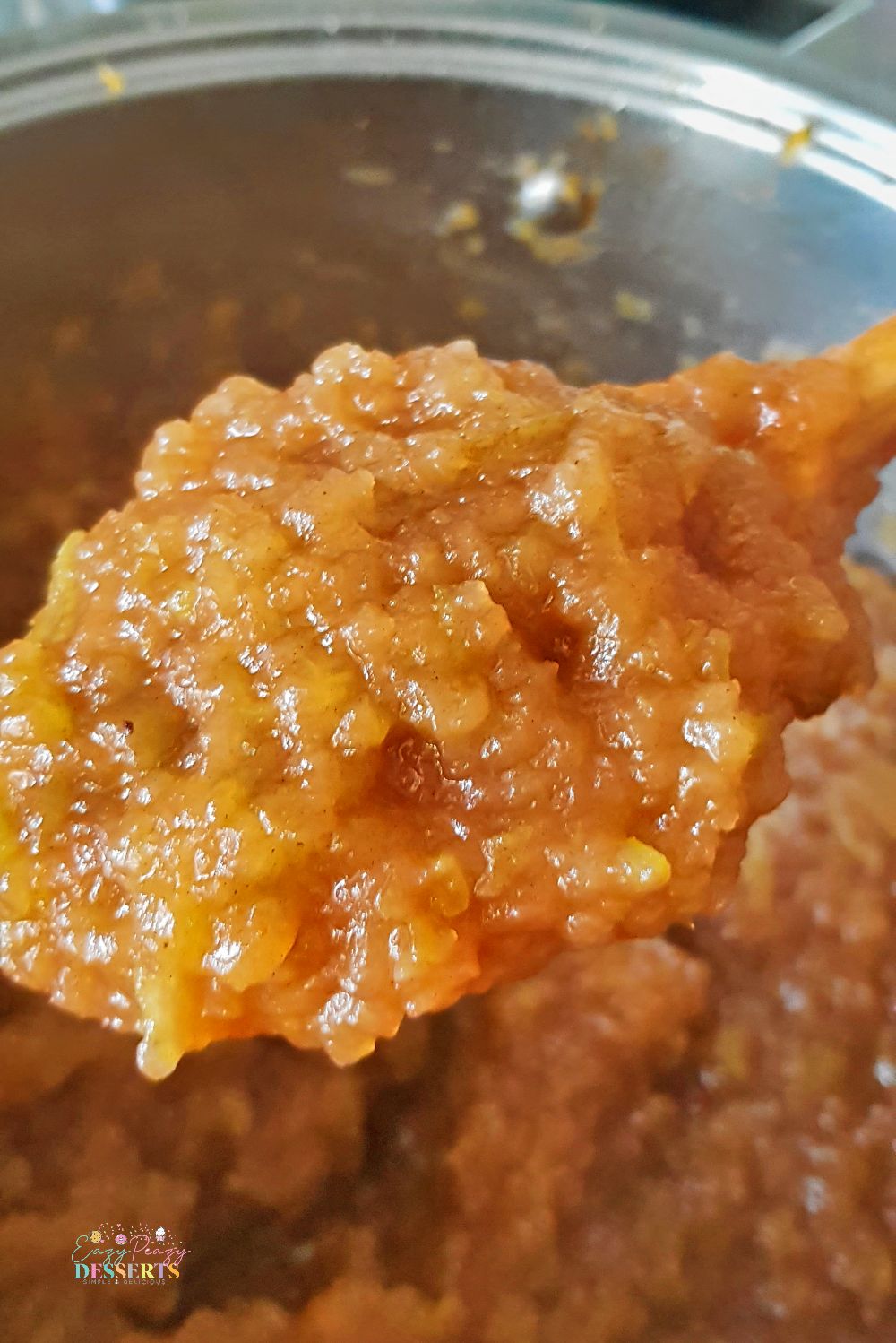 Close up image of homemade apple sauce in a wooden spoon