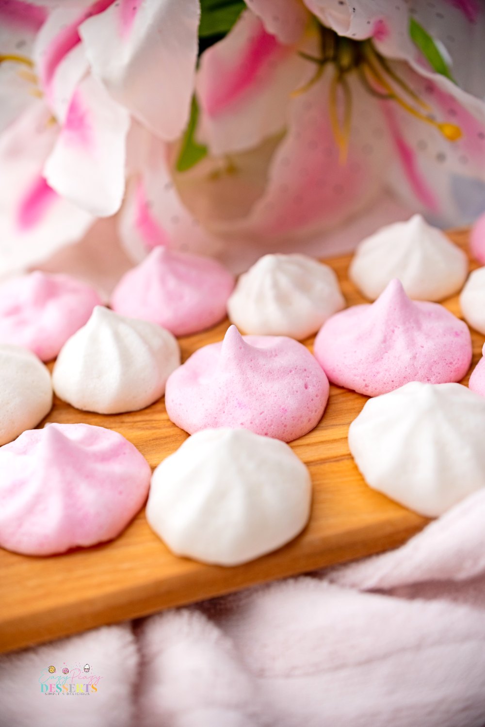 Close up image of pink and white vegan meringue cookies