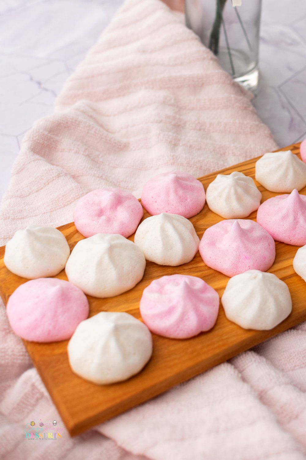 Close up image of vegan meringues in pink and white colors