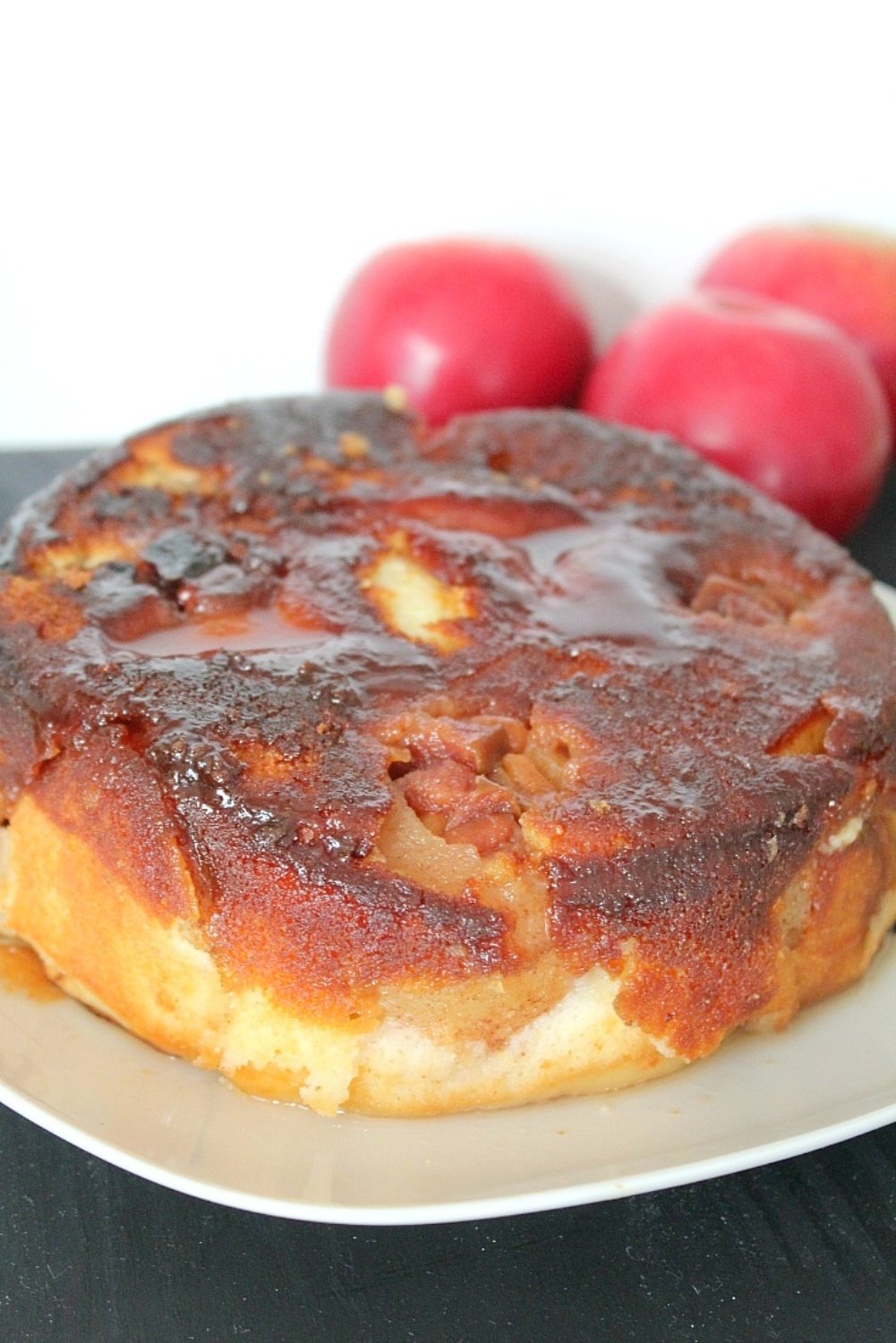 Close up image of apple upside down cake on a plate