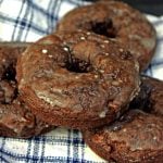 Image of a few chocolate donuts with sugar glaze