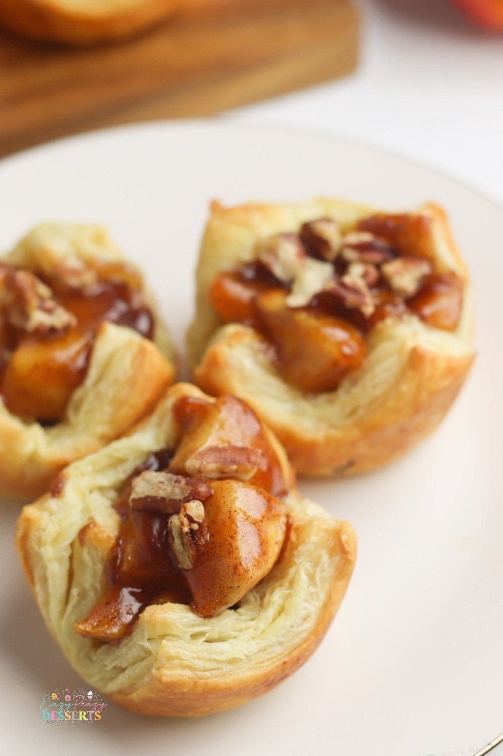 Close up image of mini apple pies in puff pastry cups