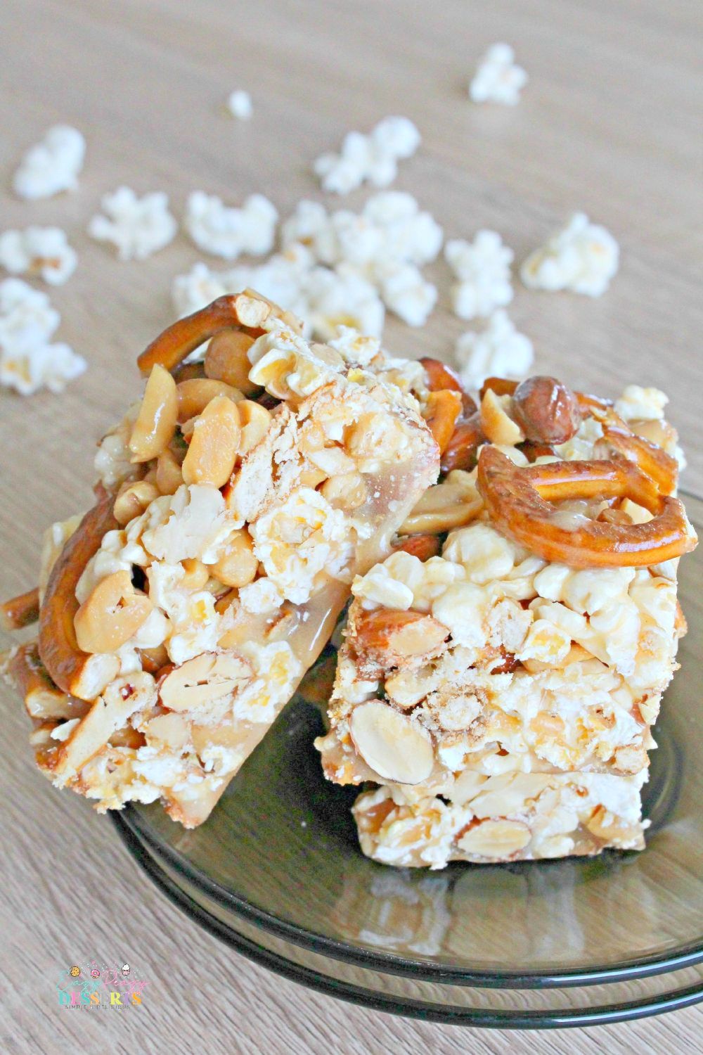 Image of 3 bars of popcorn dessert with caramel, pretzel and mixed nuts