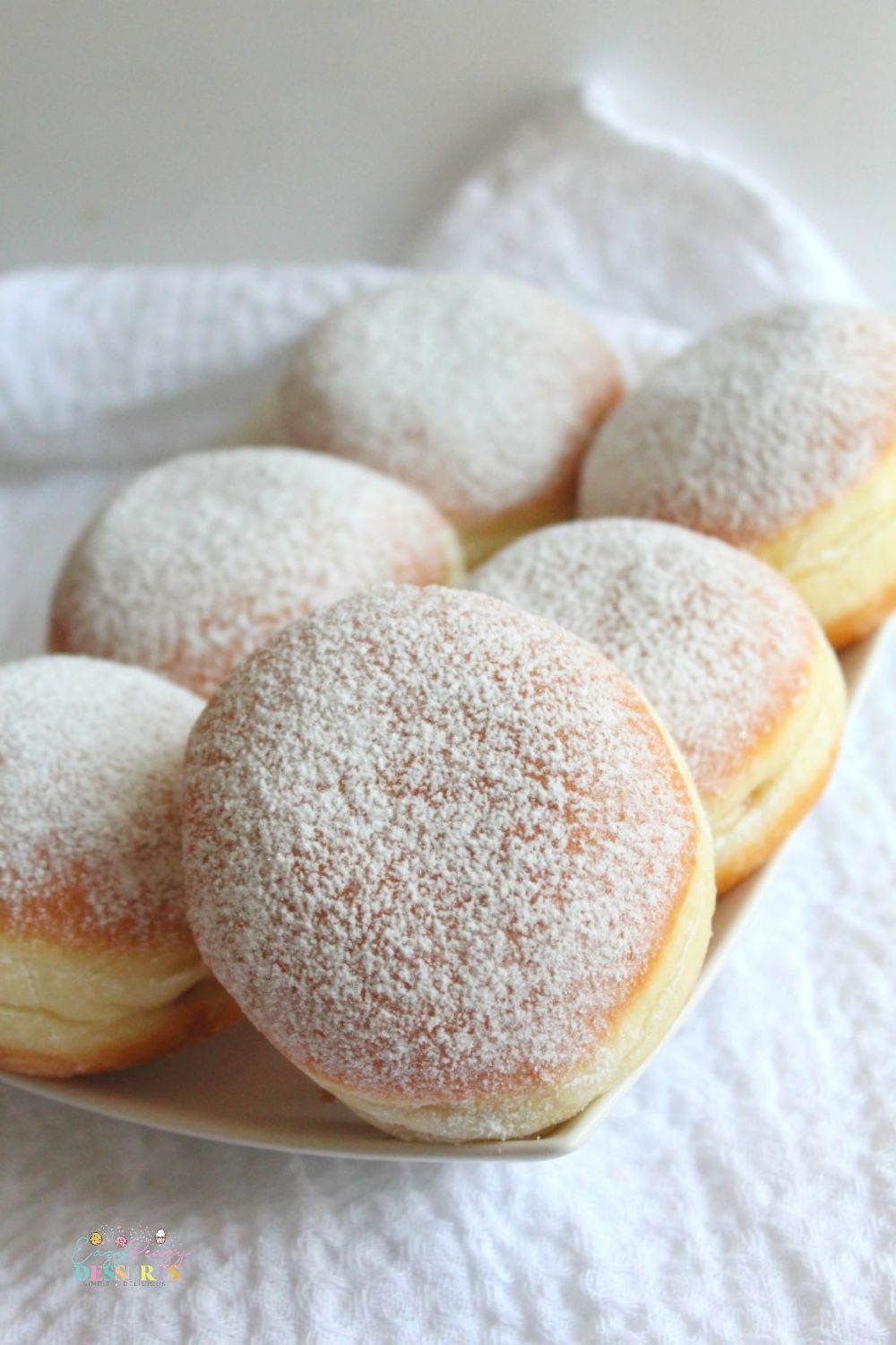 Close p image of jelly donuts filled with strawberry jam