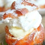 Close up image of cream puffs filled with custard and whipped cream