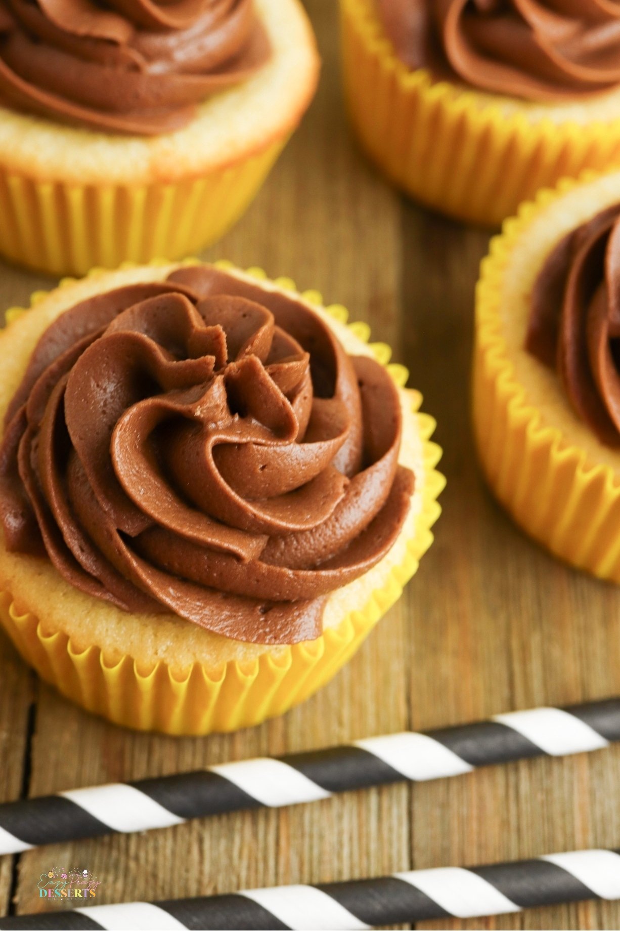 Soft, fluffy, and topped with rich chocolate buttercream, these yellow cupcakes are a must-bake treat for any occasion!